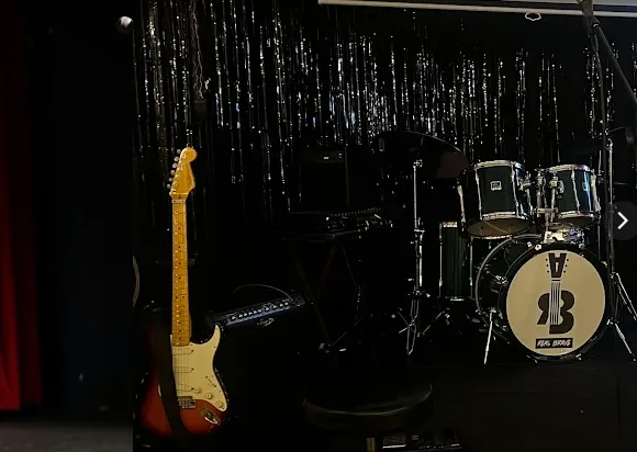 Stage at Real Brave Oakland with guitar and drum kit