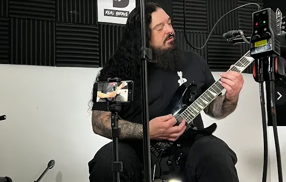 Guitar instructor recording a lesson video at Real Brave NJ