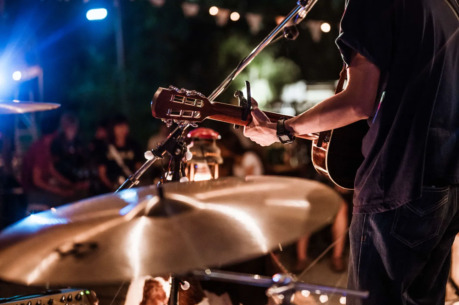 Bass lessons — Real Brave student performing bass on a live stage